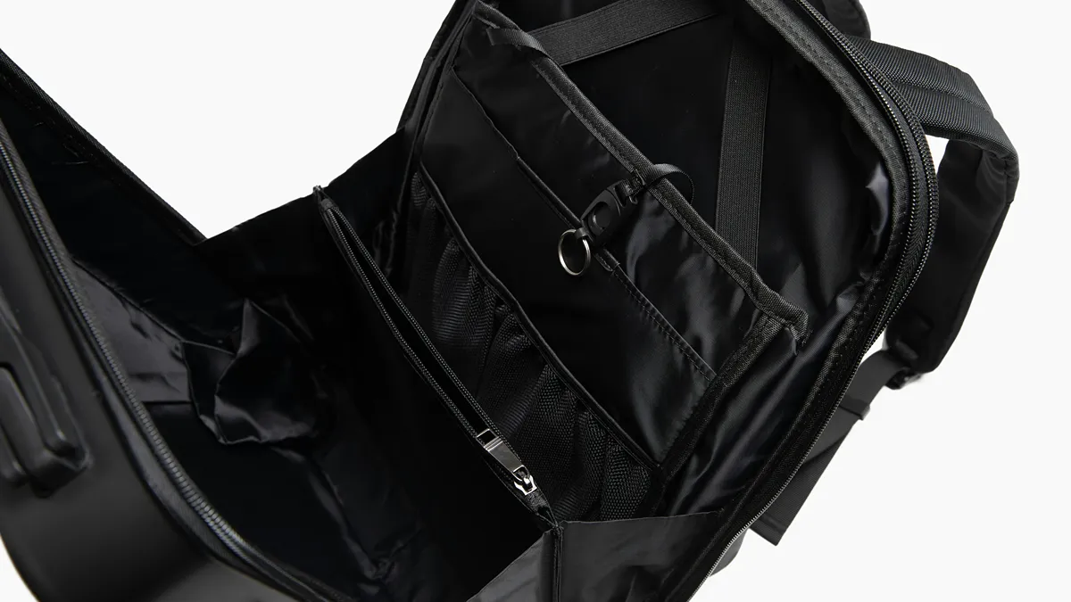 interior storage compartments of an open black travel backpack